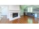 Well-lit bonus room with a fireplace, wet bar, hardwood floors, and natural light from a window at 10765 Shallowford Rd, Roswell, GA 30075