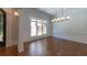 Bright dining room boasts hardwood floors, coffered ceilings, and modern chandelier at 10765 Shallowford Rd, Roswell, GA 30075