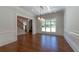 Spacious dining room featuring detailed trim, hardwood floors, and coffered ceiling at 10765 Shallowford Rd, Roswell, GA 30075