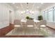 Formal dining area with sophisticated wainscoting and large windows at 10765 Shallowford Rd, Roswell, GA 30075