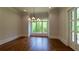 Dining room features hardwood floors and a view of the wooded yard at 10765 Shallowford Rd, Roswell, GA 30075