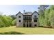 Spacious two-story home featuring a balcony and well-manicured lawn, perfect for outdoor living at 10765 Shallowford Rd, Roswell, GA 30075