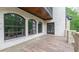 Backyard brick exterior with a covered deck, arched windows, and wood paneled ceiling at 10765 Shallowford Rd, Roswell, GA 30075