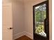 An ornate iron door welcomes you into the entry foyer, showcasing hardwood floors and an adjacent interior doorway at 10765 Shallowford Rd, Roswell, GA 30075