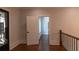 Entry foyer featuring hardwood floors, an ornate iron door, and access to a separate hallway through an open doorway at 10765 Shallowford Rd, Roswell, GA 30075