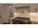 Kitchen features stainless steel range with pot filler, white subway tile backsplash and custom cabinets at 10765 Shallowford Rd, Roswell, GA 30075