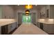 Expansive kitchen with large island, stainless steel appliances, wine fridge, and stylish pendant lighting at 10765 Shallowford Rd, Roswell, GA 30075