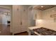Gourmet kitchen shows off stainless steel range and custom cabinetry, with a view into a living room at 10765 Shallowford Rd, Roswell, GA 30075