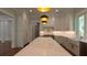 Bright kitchen boasts an oversized island, custom cabinets, stainless appliances, and designer light fixtures at 10765 Shallowford Rd, Roswell, GA 30075