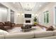 Elegant living room with a fireplace, modern lighting, and stylish furnishings at 10765 Shallowford Rd, Roswell, GA 30075