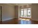 Bright living room features hardwood floors, large windows, and elegant trim work at 10765 Shallowford Rd, Roswell, GA 30075