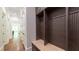 Functional mudroom area featuring custom lockers, a bench, and ample storage space for organization at 10765 Shallowford Rd, Roswell, GA 30075