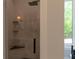 Modern shower featuring marble-style tiles, a glass enclosure, and built-in shelving at 10765 Shallowford Rd, Roswell, GA 30075