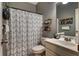 Cozy bathroom featuring a shower with patterned curtains and decorative shelves for storage at 1120 Bentwater Dr, Acworth, GA 30101
