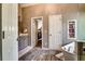 Beautiful bathroom with stylish wood-look flooring, bathtub, and convenient access to a walk-in closet at 1120 Bentwater Dr, Acworth, GA 30101