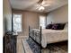 Cozy bedroom with iron frame bed, welcome pillows, an area rug, and natural light from windows at 1120 Bentwater Dr, Acworth, GA 30101