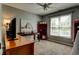 Bedroom with a desk area, artwork, red bookshelf, and natural light from a large window at 1120 Bentwater Dr, Acworth, GA 30101