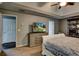 Bedroom boasts tray ceiling, ceiling fan, dresser with TV, and access to additional rooms at 1120 Bentwater Dr, Acworth, GA 30101