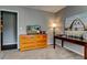 Bedroom showcasing dresser, TV, desk, and a charming rustic artwork at 1120 Bentwater Dr, Acworth, GA 30101