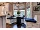 Charming breakfast nook with built-in bench seating, a dark wood table, and large windows at 1120 Bentwater Dr, Acworth, GA 30101
