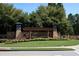 Stone entrance to Bentwater community with lush landscaping and mature trees at 1120 Bentwater Dr, Acworth, GA 30101