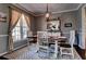 Dining room with wooden table, decorative rug, and natural light from the window at 1120 Bentwater Dr, Acworth, GA 30101