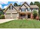 Charming home with a manicured lawn, two-car garage, and welcoming front porch at 1120 Bentwater Dr, Acworth, GA 30101