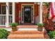 Welcoming front porch with brick steps, potted plants, and a 'Welcome' sign at 1120 Bentwater Dr, Acworth, GA 30101