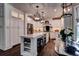 Bright kitchen featuring an island with wine rack, stainless appliances, and modern pendant lighting at 1120 Bentwater Dr, Acworth, GA 30101