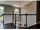 Upstairs landing with hardwood floors, natural light, and wrought iron railing at 1120 Bentwater Dr, Acworth, GA 30101