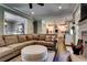 Living room showcasing a large sectional sofa, fireplace, and view into the kitchen at 1120 Bentwater Dr, Acworth, GA 30101