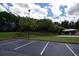 View of parking lot for Bentwater pickleball courts, with mature trees, picnic and play area in the background at 1120 Bentwater Dr, Acworth, GA 30101