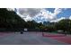Outdoor pickleball courts with lighting and black fencing are surrounded by mature trees at 1120 Bentwater Dr, Acworth, GA 30101