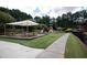 Community playground with shade cover, picnic tables, slides and play structures for families to enjoy at 1120 Bentwater Dr, Acworth, GA 30101