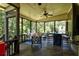 Spacious screened porch with comfortable seating, a dining area, and a serene backyard view at 1120 Bentwater Dr, Acworth, GA 30101