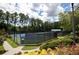 View of community tennis courts with lush green landscaping and mature trees at 1120 Bentwater Dr, Acworth, GA 30101