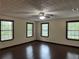 Spacious bedroom with hardwood flooring, neutral walls, a ceiling fan and bright, natural light at 1253 Todiway Ct, Jonesboro, GA 30238