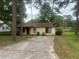 Inviting single-story home with mature trees, a well-maintained yard, and a concrete driveway at 1253 Todiway Ct, Jonesboro, GA 30238
