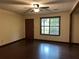 Bright living room with dark hardwood floors, ceiling fan, and natural light from the window at 1253 Todiway Ct, Jonesboro, GA 30238