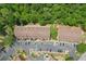 Aerial view of the community showcasing townhomes, landscaping, parking, and proximity to green spaces at 4216 Stillwater Dr, Duluth, GA 30096
