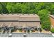 Aerial view of townhomes featuring well-maintained roofs, private entrances, landscaping, and parking at 4216 Stillwater Dr, Duluth, GA 30096