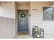 Inviting front door with a wreath and a 'Hello Sunshine' welcome mat, and potted plants at 4216 Stillwater Dr, Duluth, GA 30096