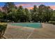 Large community pool with surrounding lounge chairs and beautiful mature trees at 4216 Stillwater Dr, Duluth, GA 30096