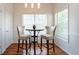 Bright breakfast nook features hardwood floors, a table with two stools and natural light at 4252 River Green Dr # 501, Atlanta, GA 30327