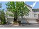 Multi-story home with multiple garages, trees, and landscaping at 4252 River Green Dr # 501, Atlanta, GA 30327