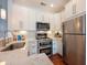 Bright kitchen features stainless appliances, granite countertops, and modern white cabinets at 4252 River Green Dr # 501, Atlanta, GA 30327