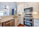 Bright kitchen features stainless appliances, granite countertops, and modern white cabinets at 4252 River Green Dr # 501, Atlanta, GA 30327