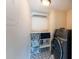 Functional laundry room with modern washer and dryer, plus storage shelves at 4252 River Green Dr # 501, Atlanta, GA 30327