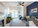 Bright living room with tall ceilings, balcony access, fireplace, and modern ceiling fan at 4252 River Green Dr # 501, Atlanta, GA 30327