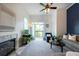 Cozy living area with fireplace, balcony access, and a stylish ceiling fan at 4252 River Green Dr # 501, Atlanta, GA 30327